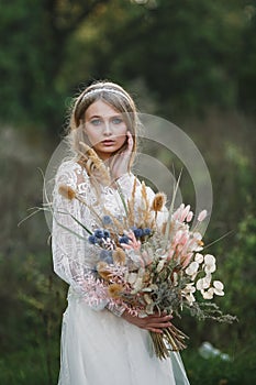 A young cute girl in a white dress poses beautifully. Positive attitude