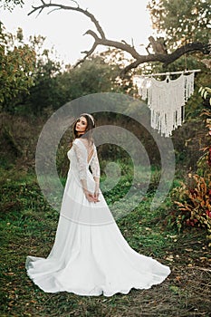 A young cute girl in a white dress poses beautifully. Positive attitude