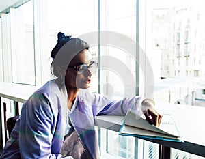 Young cute indian girl at university building sitting on stairs