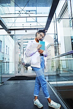 young cute indian girl at university building sitting on stairs,