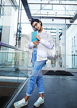 Young cute indian girl at university building sitting on stairs