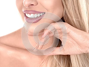 Young cute smiling girl showing her perfect teeth, isolated on white Copy space. Perfect smile. Stomatology concept.
