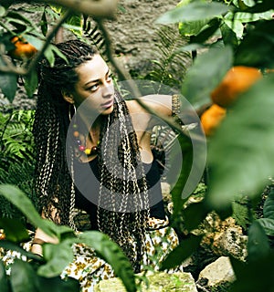 Young cute smiling woman in park with oranges