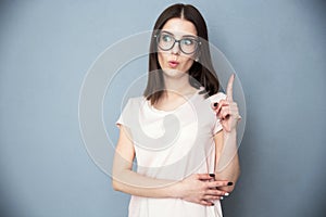 Young cute woman in glasses having idea