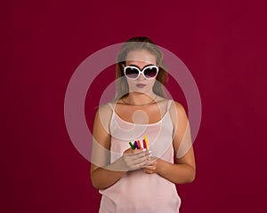 Young cute woman with markers, studio