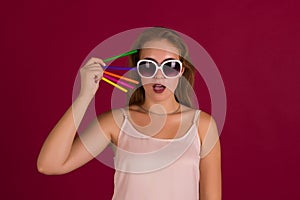 Young cute woman with markers, studio