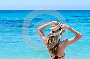 Young cute woman over turquoise sea at tropical beach during vacation