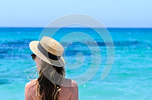 Young cute woman over turquoise sea at tropical beach during vacation