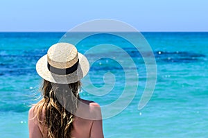 Young cute woman over turquoise sea at tropical beach during vacation