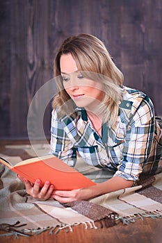 Young cute woman reading a book