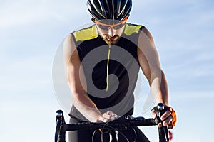 Young cyclist man setting timer on bicycle in sports gear.