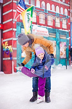 Young dad and adorable little girl have fun on