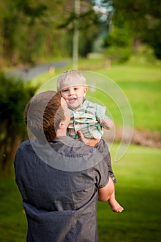 A young Dad with his little boy outdoors