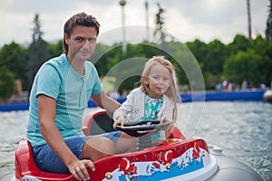 Young dad and his little girl riding on an airboat