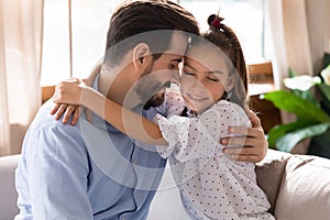 Young dad and little daughter hug enjoying tender moment