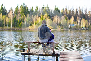 Young dad and little girl fishing on the lake