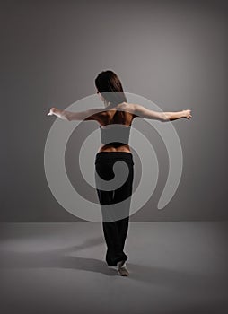 Young and dancer over grey background