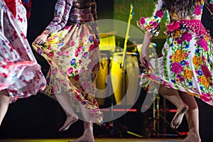 Young dancer woman barefoot in gypsy dress dancing on stage