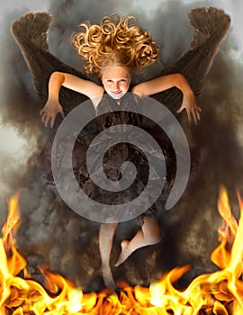 Young dark angel rising from the flames