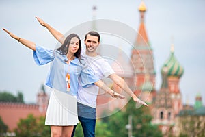 Young dating couple in love walking in city background St Basils Church