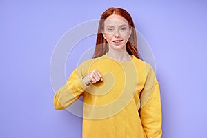 Young deaf mute cheerful woman teaching how to speak sign language