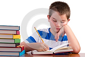 Young dedicated middle school male kid studying