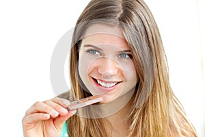 Young delighted woman eating chocolate