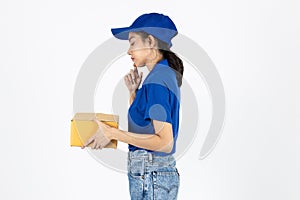 Young delivery Asian woman in blue uniform holding package over white isolated background