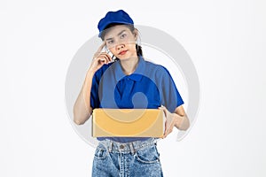 Young delivery Asian woman in blue uniform holding package over white isolated background