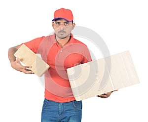 Young delivery man carrying carton boxes in uniform