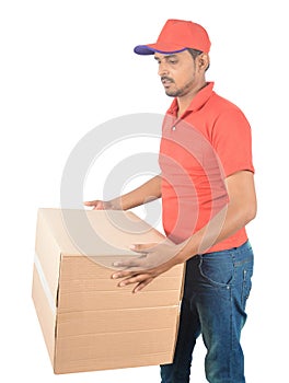 Young delivery man carrying carton boxes in uniform