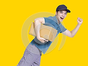 Young delivery man run quickly and holding the parcel box