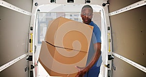 Young Delivery Men Loading Cardboard Boxes