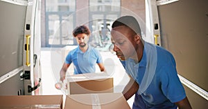 Young Delivery Men Loading Cardboard Boxes