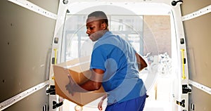 Young Delivery Men Loading Cardboard Boxes