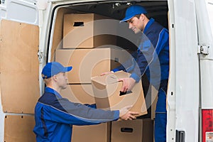Delivery Men Unloading Boxes From Truck