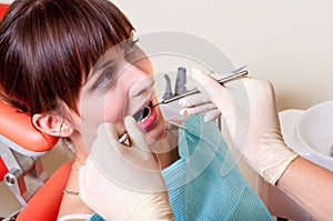 Young dentist giving a treatment to his patient