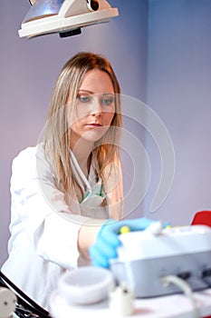 Young dentist woman or nurse working in dental office.