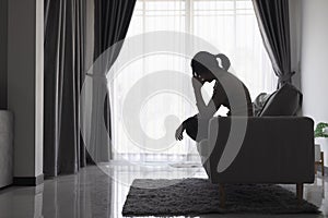 Young depressed woman domestic and rape violence beaten and raped sitting in the corner International Day for the Elimination