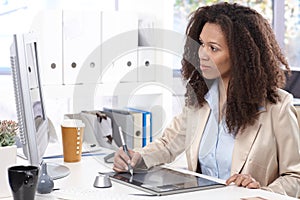 Young designer at desk with drawing pad