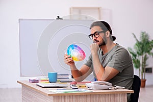 Young male designer working in the office