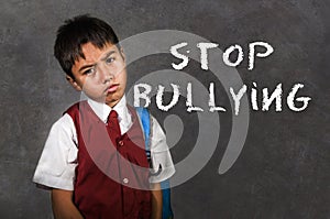 Young desperate abused schoolboy screaming crying victim of bullying and abuse at school on blackboard in bullied kid soc