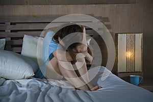 Young desperate and depressed woman crying in bed at night having depression problem and anxiety crisis feeling sad as girl