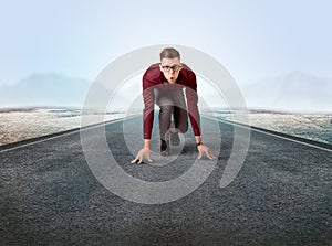 Businessman kneeling in ready position