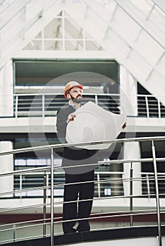 Young developer near building.