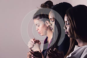 Young Devoted Women Praying Together