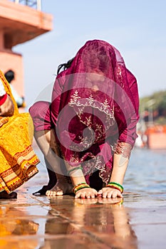 young devotee praying for holy god after bathing in holy river water at morning from flat angle photo