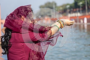 young devotee praying for holy god after bathing in holy river water at morning from flat angle photo