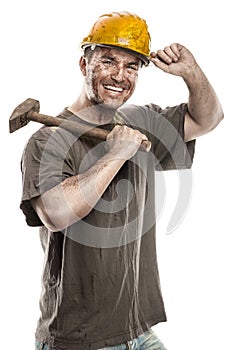 Young dirty Worker Man With Hard Hat helmet holding a hammer