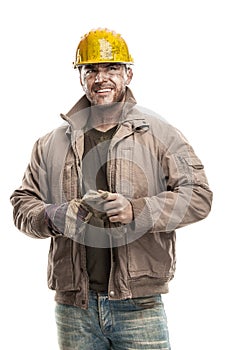 Young dirty Worker Man With Hard Hat helmet holding a work glo